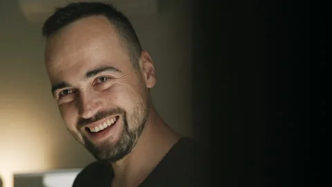 Portrait of man with beard smiling and laughing, nods in happiness. Slowmotion Stock Footage 152540238