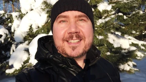 Portrait of a man with a beard in the winter forest. Happy smiling man Video stock 167603523