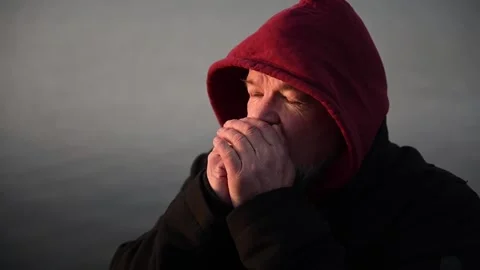 Portrait of a man with beard,wrinkles, he is cold, close-up warms his hands. Stock Footage 170194451