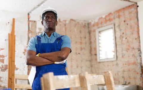 Portrait of man builder standing in construction site Stock Photos