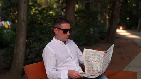 Portrait of a man close-up on a background of trees in the park. A man in a park Video stock 139593015
