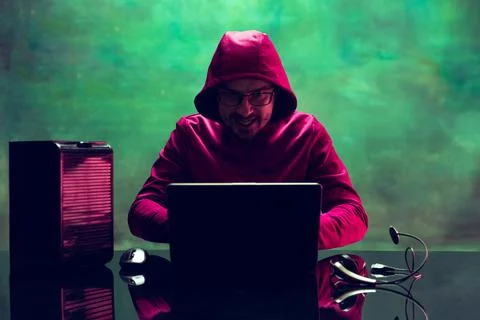 Portrait of man, computer geek, hacker working with laptop, breaking security Stock Photos