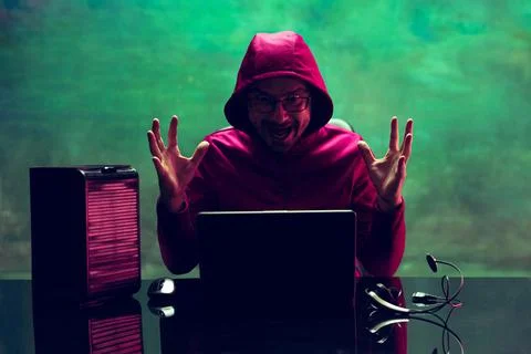 Portrait of man, computer geek, hacker working with laptop, breaking security Stock Photos