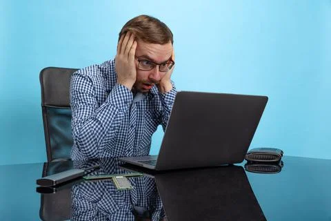 Portrait of man, computer system analyst touching head in shock, working with Stock Photos