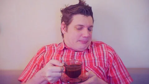 Portrait of a man with a cup of coffee which was not pleasant Stock Footage 86386878