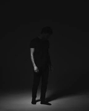 Portrait of a man in a dark key in the studio Stock Photos