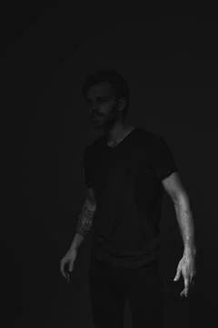 Portrait of a man in a dark key in the studio Stock Photos