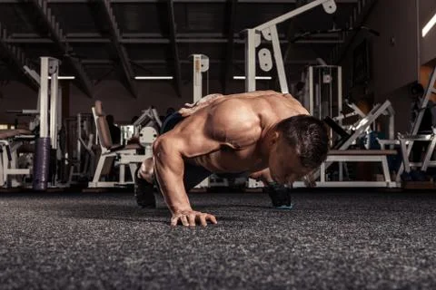 Portrait of a  man doing push ups exercise with one hand Stock Photos