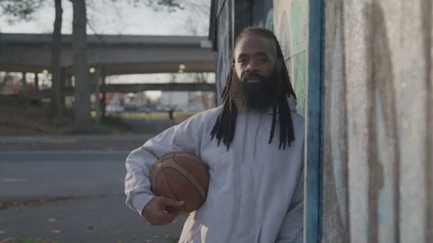 Portrait of Man with Dreadlocks and Beard Holding Basketball Under His Arm at Stock-Footage 270397310