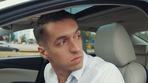 Portrait of man driver is drinking an alcoholic drink while sitting in a car. Stock-Footage 131540766