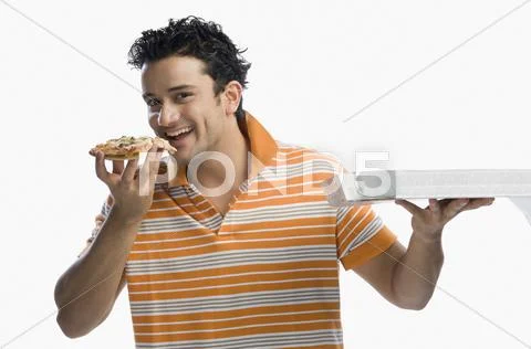 Portrait of a man eating pizza and smiling Stock Photos