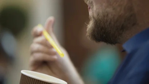 Portrait of a man eats coffee foam and plays with it drink Video stock 102546321