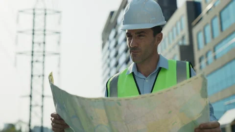 Portrait of man engineer in helmet examining blueprint Stock Footage 308464502
