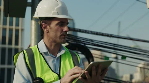Portrait of man engineer in helmet working on tablet at construction site Stock Footage 308464636
