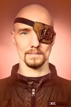 Portrait of man with eye patch of steampunk style on his face 스톡 사진