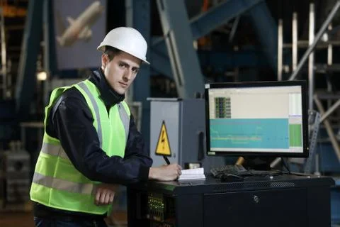 Portrait of a man , factory engineer in work clothes controlling the work Stock Photos