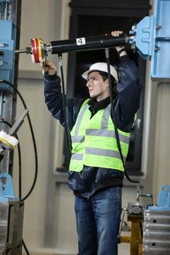 Portrait of a man , factory engineer in work clothes controlling the work Stock Photos