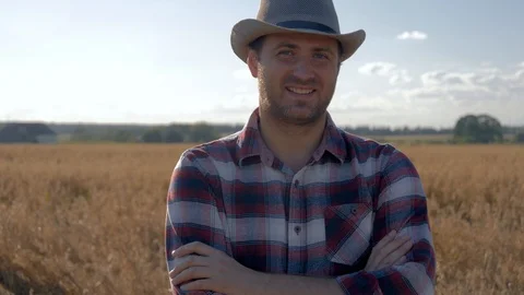 Portrait Of A Man Farmer Standing In A Wheat Field On A Sunny Summer Day Stock Footage 105364095