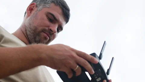 A portrait of a man focused on a drone controller. Stock Footage 321727679
