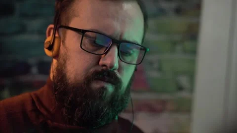 Portrait of Man With Glasses Working on Computer From 1980's and Listening Stock Footage 305571144