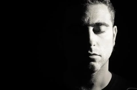 Portrait of a man with half face on shadow Stock Photos