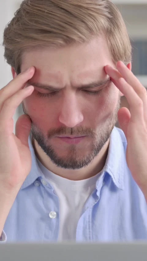 Portrait of Man having Headache while using Laptop, Vertical Video Stock Footage 339579197