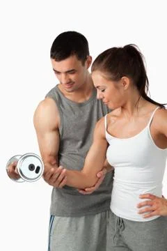 Portrait of a man helping a woman to work out Stock Photos