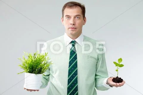 Portrait of a man holding different plants in hands Stock Photos