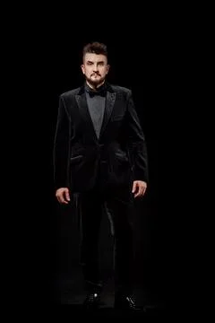 Portrait of a man in a jacket and in the studio on a black background Stock Photos