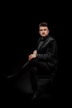 Portrait of a man in a jacket and in the studio on a black background Stock Photos