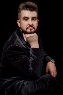 Portrait of a man in a jacket and in the studio on a black background Stock Photos