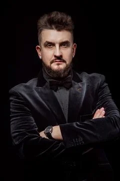 Portrait of a man in a jacket and in the studio on a black background Stock Photos