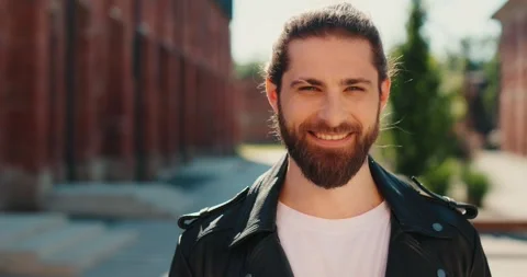 Portrait of man in leather jacket standing in street and looking at camera. Stock Footage 246753744