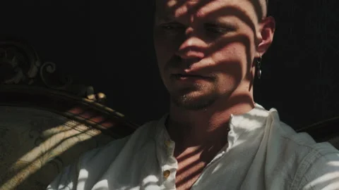 Portrait of a man in light and shadow Stock Footage 239470448