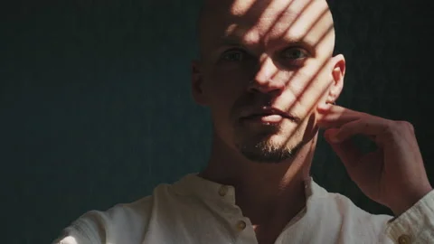 Portrait of a man in light and shadow Stock Footage 239470734