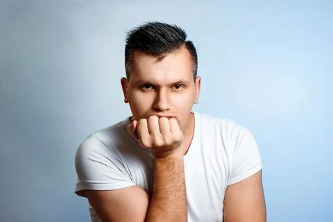 Portrait of a man on a light background, bored, emotion of boredom. The conce Stock Photos