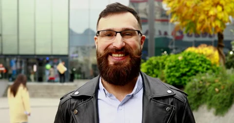 Portrait man with long beard  standing on the street and smiling. Stock Footage 221904661