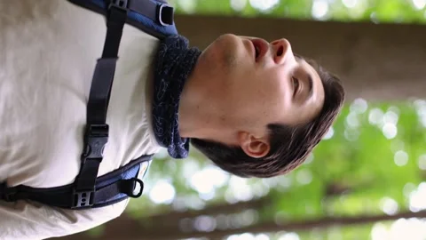 Portrait of a man looking back in the forest close-up vertical frame Vidéo 252525519