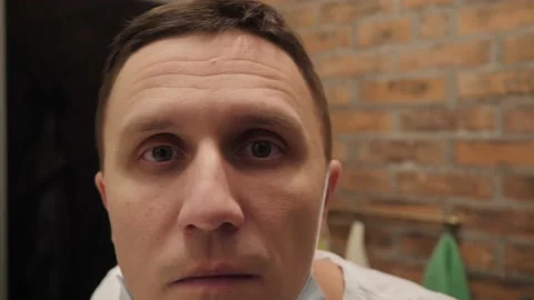 Portrait of a man looking at the camera close up Видео 144384250
