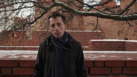 Portrait of a man looking directly at the camera on a winter day Stock Footage 311192833