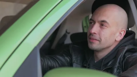 Portrait of a man looking out of the window of a parked car. Video stock 153071500