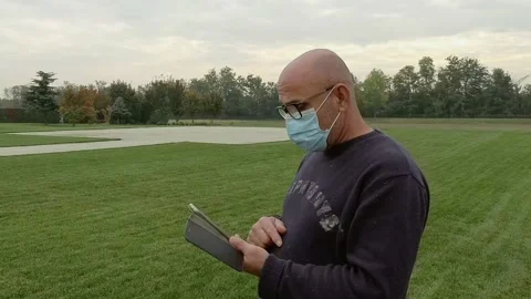 Portrait of Man Looking at Smartphone While Wears a Medical Mask Stock Footage 141606247