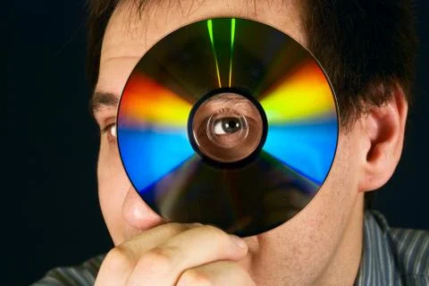 Portrait of a man looking through a cd Stock Photos