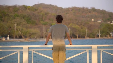 Portrait of Man Looking at View of Ocean and Island While on Vacation Stock Footage 126260070