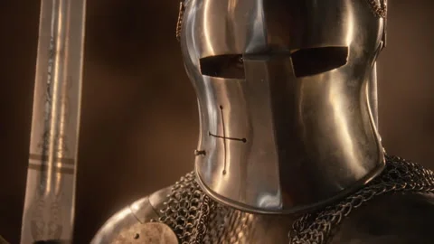 Portrait of Man in Medieval Knight Armor Lowering Visor with Sword Stock Footage 345520358