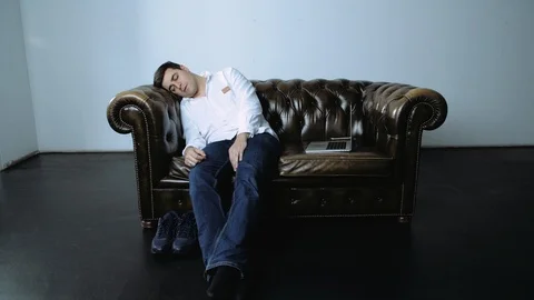 Portrait of Man Napping Seated on Leather Couch Stock Footage 120423161