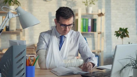 Portrait of a man office worker wearing glasses with a broken arm Stock Footage 106438460