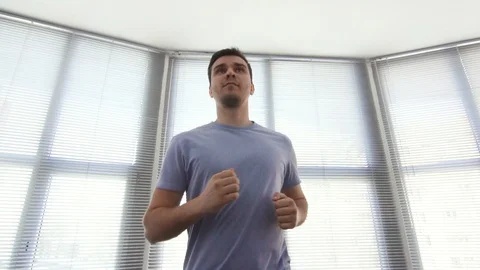 Portrait man over 30, on a running simulator,gym, slow mo Video stock 87529261