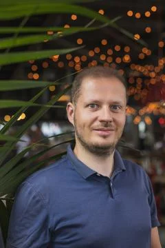 Portrait of the man in the palm tree Stock Photos