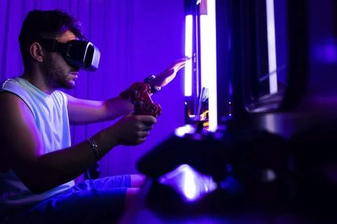 Portrait of a man playing games on the virtual reality console with a 3D glasses Stock Photos